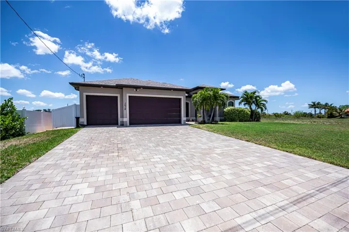 Custom built home with 3 car garage and brick paver driveway