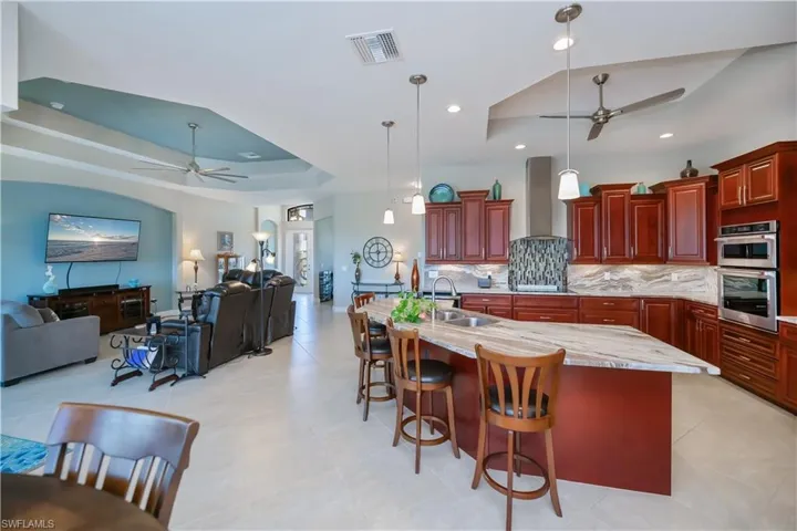 Open floor plan leads to your beautiful custom kitchen with real wood 42" cabinets  and stainless steel appliances