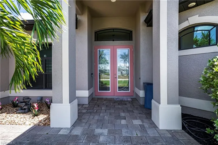 Gorgeous entryway featuring custom leaded glass french doors