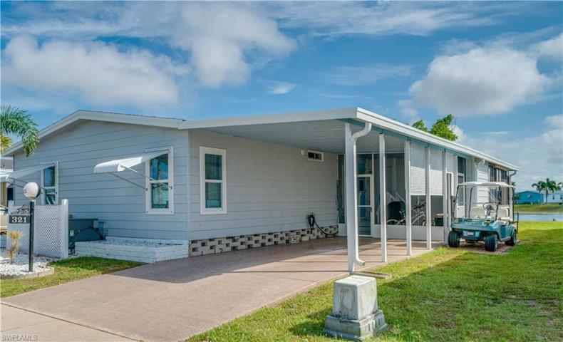 Well preserved driveway, carport, and pavered golf cart parking. Yes, this home is on the lake!