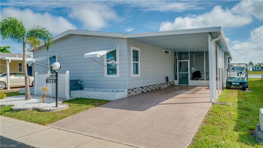 Curbing and stone accentuate this well loved home as do the new clam shell hurricane shutters.