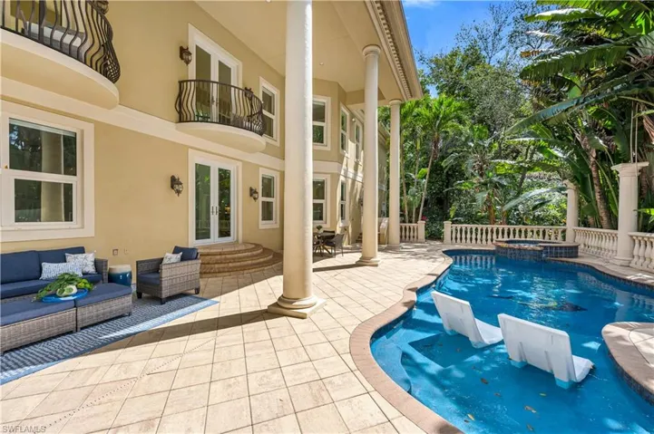 View of pool featuring a patio area, an outdoor living space, french doors, and a pool with connected hot tub