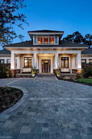 Property entrance featuring covered porch and stone siding