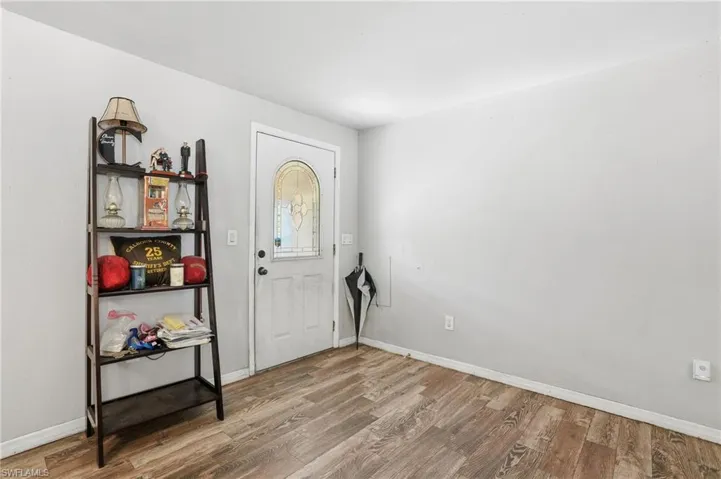 Foyer entrance featuring wood finished floors and baseboards