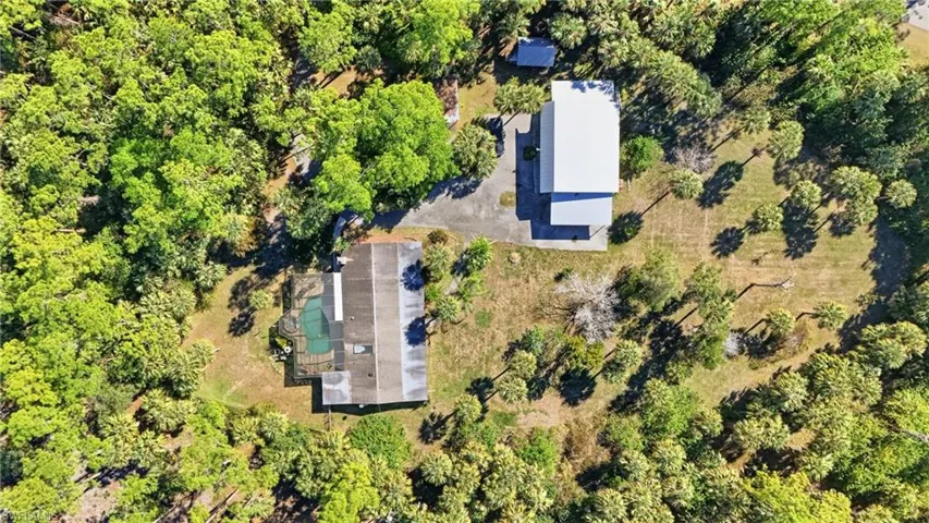 Aerial overview of property's location with a tree filled landscape