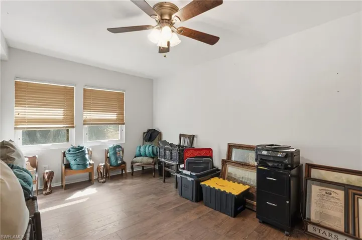 Living area featuring hardwood / wood-style floors and a ceiling fan