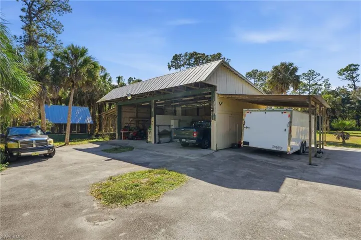 Garage featuring a carport