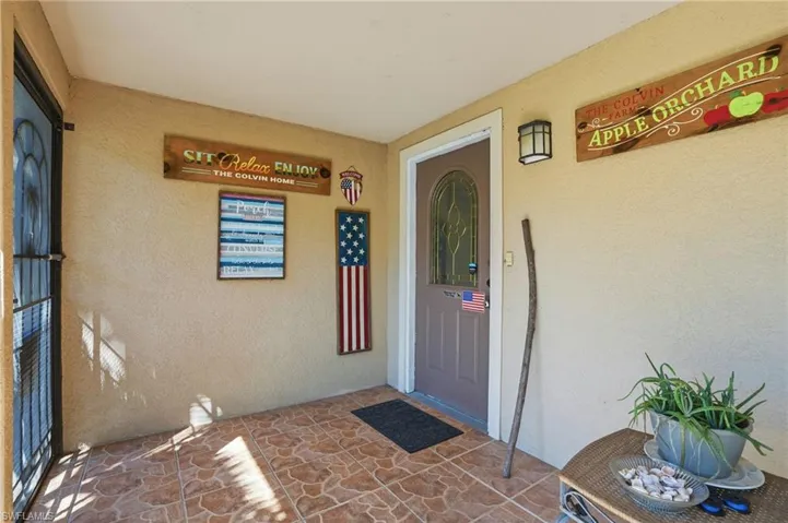 View of exterior entry featuring stucco siding