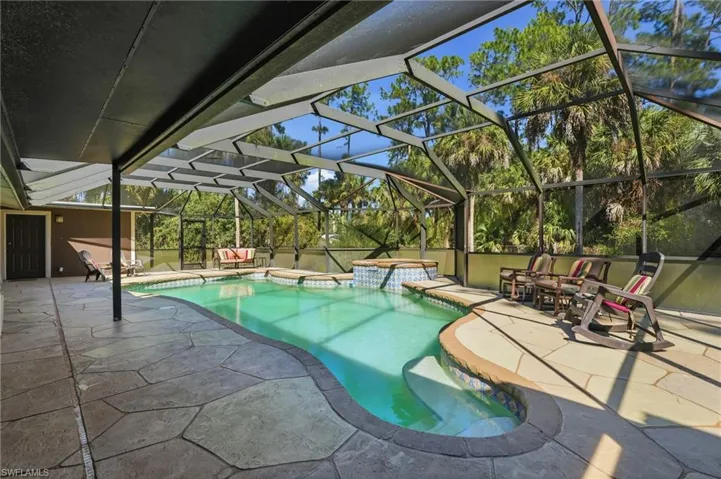 Combined pool / hot tub with a patio area, a lanai, and a sunroom