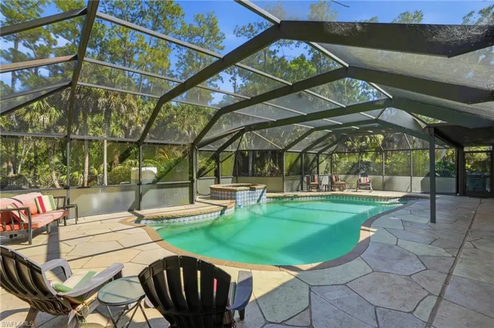 Integrated pool / spa with a lanai, a patio area, and a sunroom