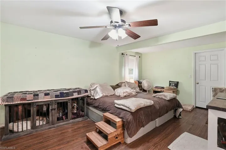Bedroom with dark wood-type flooring and ceiling fan