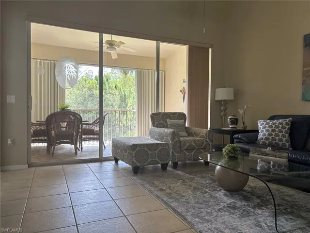 Living room with baseboards and a ceiling fan