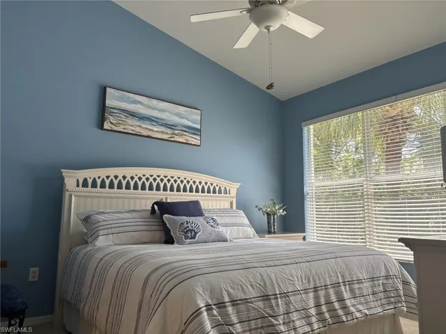 Bedroom featuring vaulted ceiling and a ceiling fan