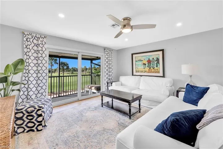 Living area with recessed lighting, wood finished floors, and ceiling fan