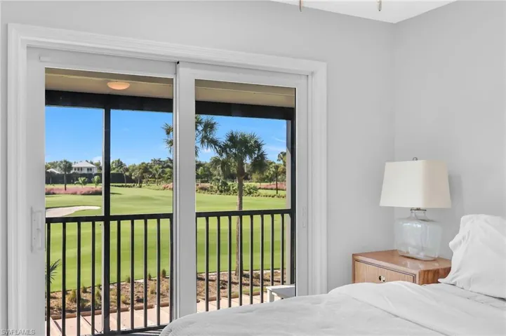 Bedroom featuring golf course view and access to exterior