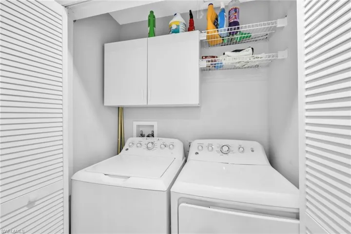 Laundry area with cabinet space and washing machine and dryer