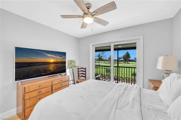 Bedroom featuring ceiling fan, access to exterior, and wood finished floors