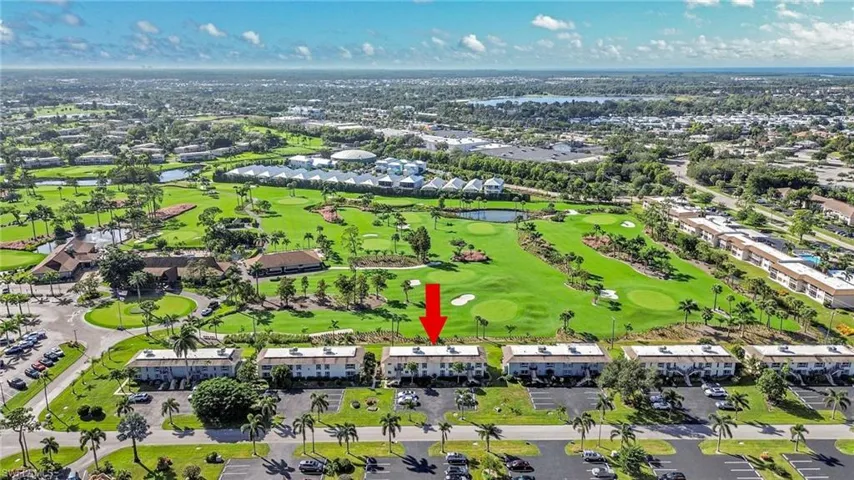 Aerial view of property and surrounding area featuring a large body of water and a local golf course