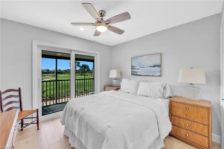 Bedroom with golf course view, access to exterior, ceiling fan, and light wood-type flooring