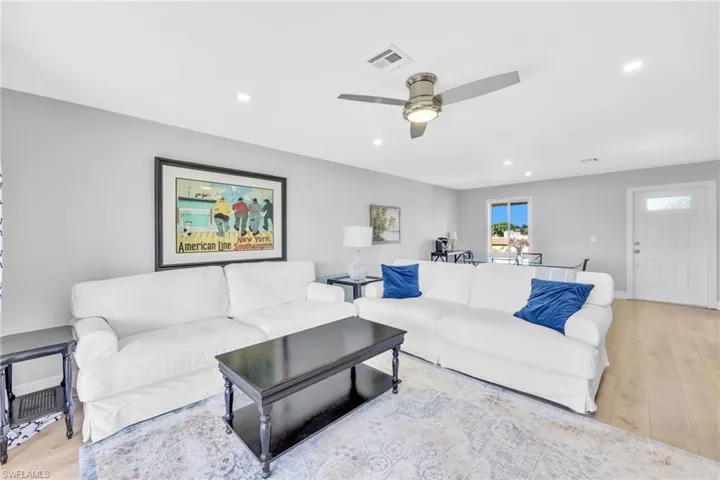 Living room featuring light wood finished floors and recessed lighting