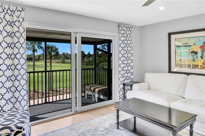 Living area featuring view of golf course, light wood-style flooring, and recessed lighting