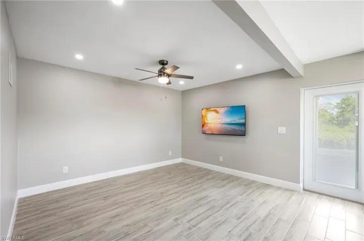 Unfurnished room with light wood-style floors, recessed lighting, a ceiling fan, and beamed ceiling