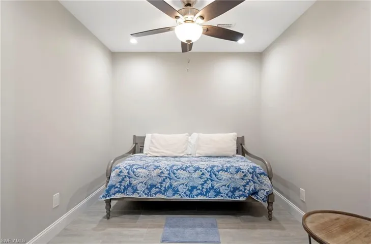 Bedroom featuring light wood finished floors, ceiling fan, and recessed lighting