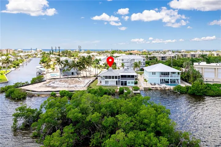 Aerial perspective of suburban area featuring a large body of water