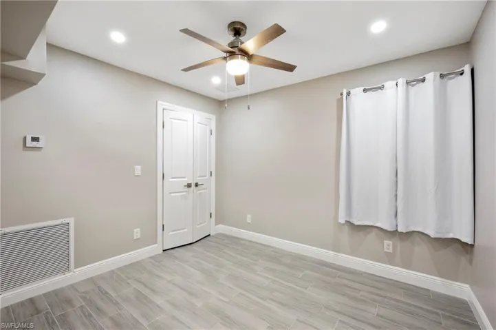 Unfurnished room featuring recessed lighting, ceiling fan, and wood tiled floors