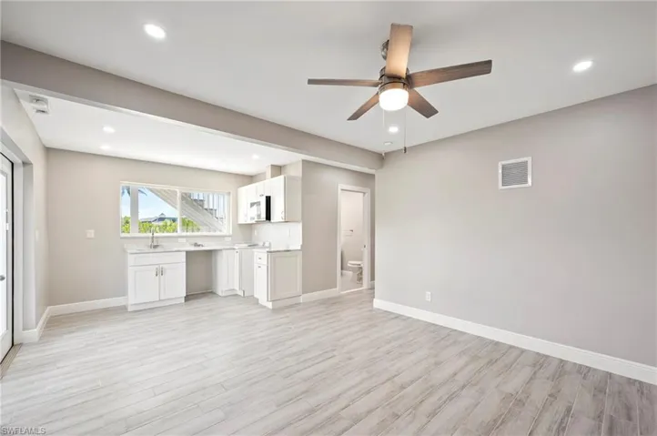 Unfurnished living room featuring light wood finished floors, recessed lighting, and a ceiling fan