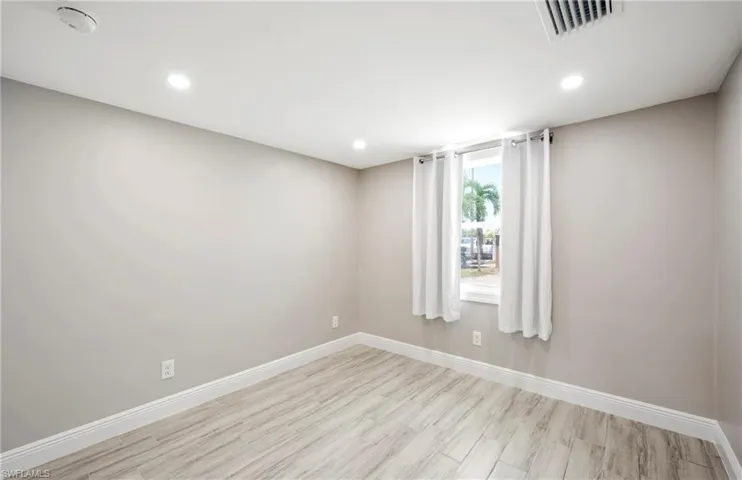 Spare room featuring wood finished floors and recessed lighting