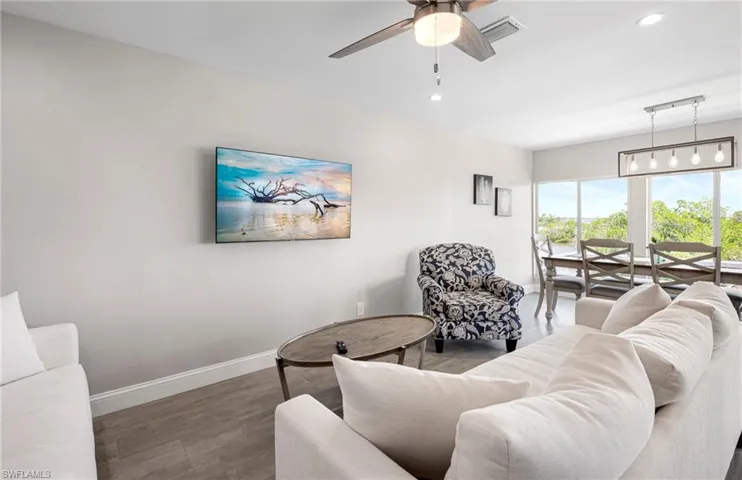 Living room with recessed lighting, wood finished floors, and ceiling fan