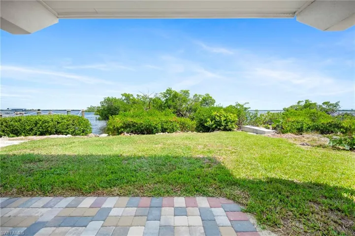 View of grassy yard with a water view