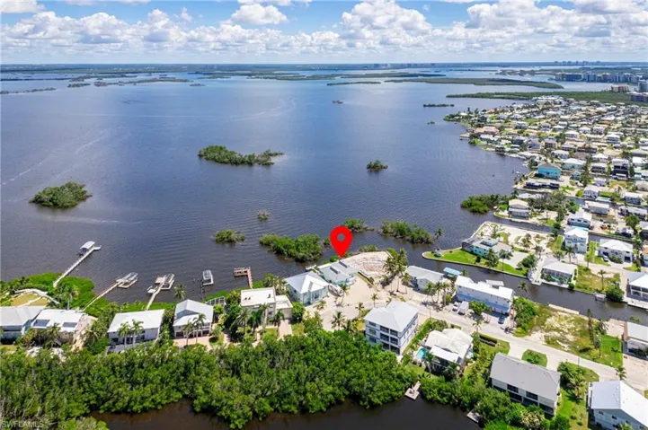 Aerial perspective of suburban area featuring a nearby body of water