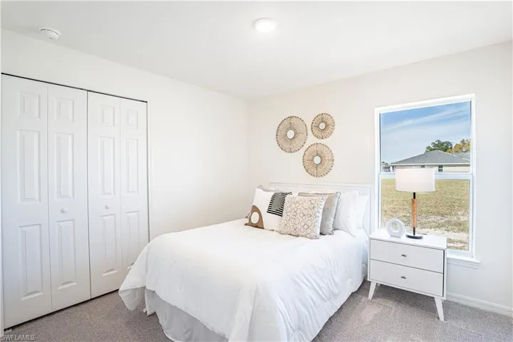 Carpeted bedroom with a closet