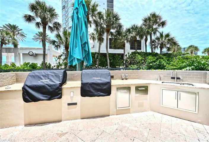 Newer gas grills with umbrella for shade or rain grilling.
