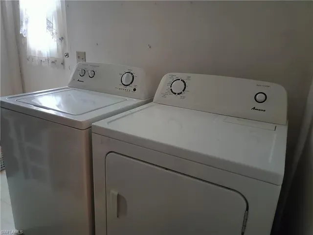 Clothes washing area featuring independent washer and dryer