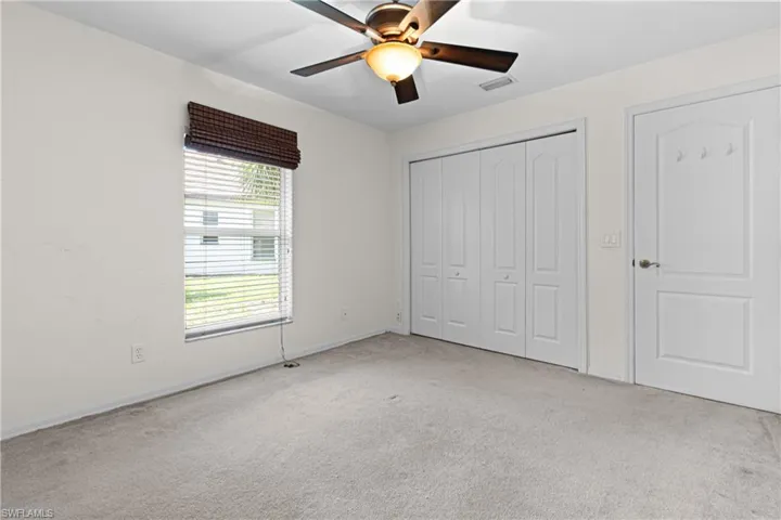 Unfurnished bedroom featuring carpet and ceiling fan