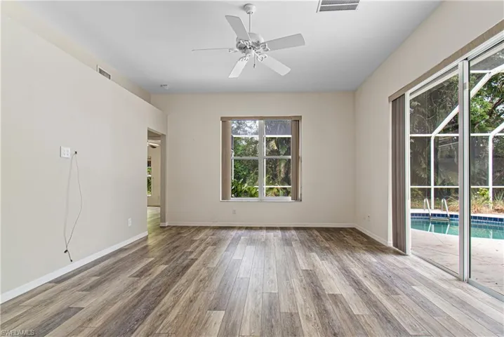 Unfurnished room featuring ceiling fan and new hardwood / wood-style floors