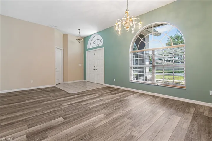 Formal Dining Room with new wood-type flooring and a healthy amount of sunlight