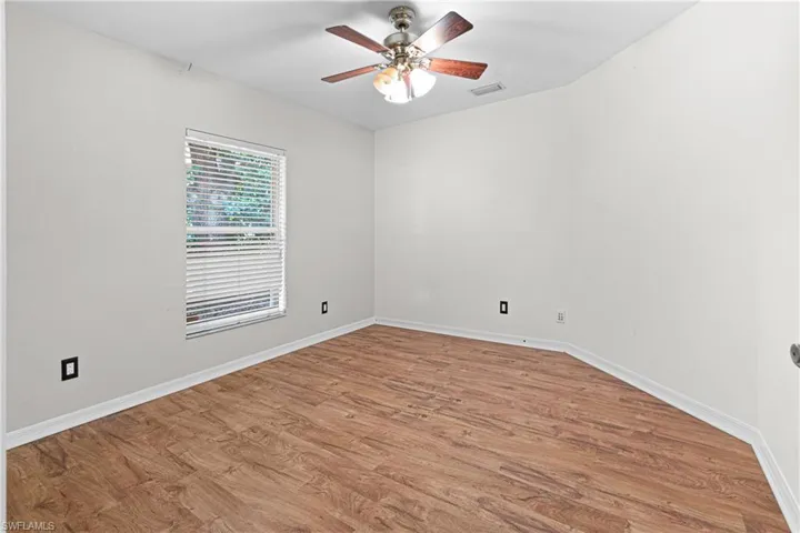 Spare room featuring wood-type flooring and ceiling fan