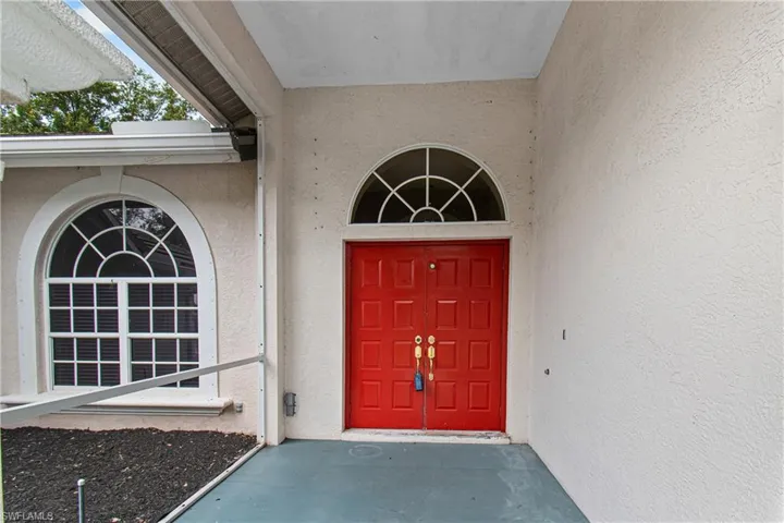 View of property entrance with screened in porch