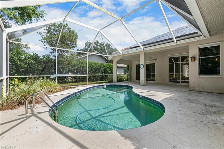 View of swimming pool featuring ceiling fan, a patio area, and a lanai