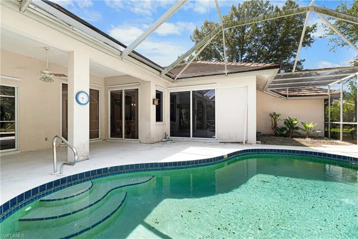 View of pool featuring a lanai, a patio, and ceiling fan