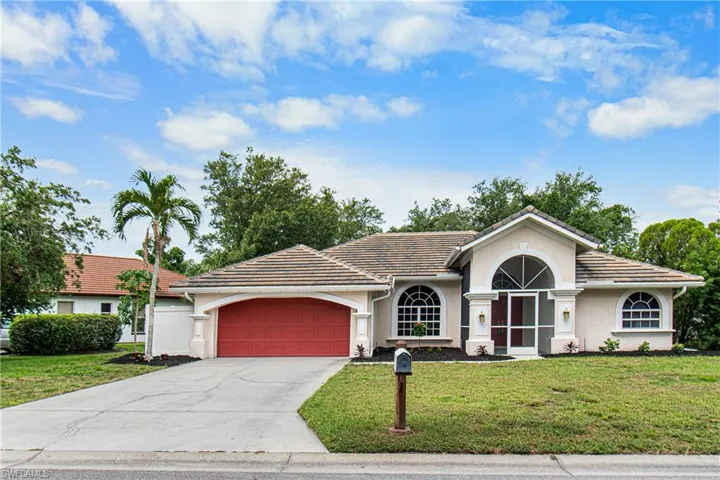 Ranch-style home featuring a garage and a front yard