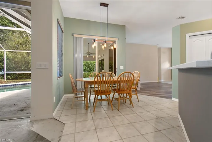 Breakfast Nook with tile flooring and hanging light