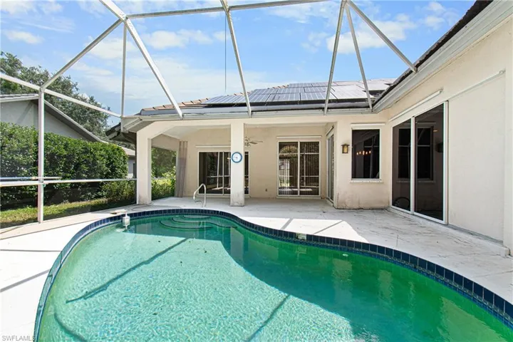 View of pool featuring a screened patio and a lanai