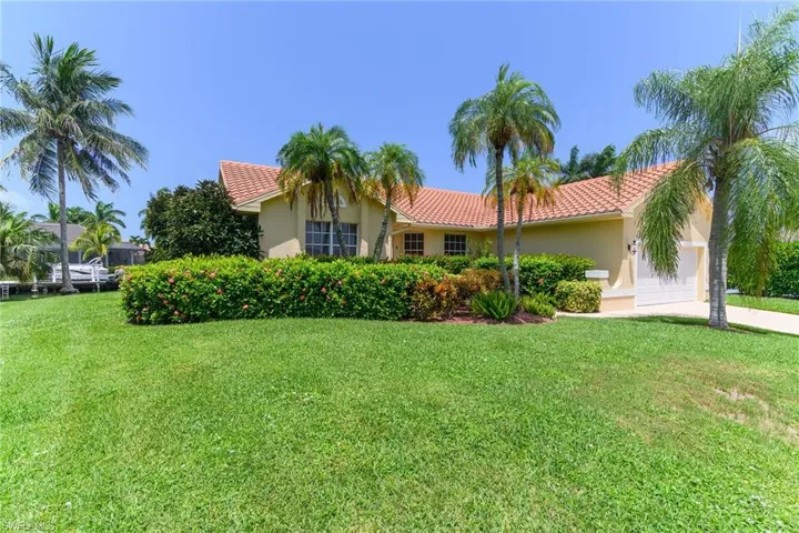 Home featuring a tile roof and stucco exterior