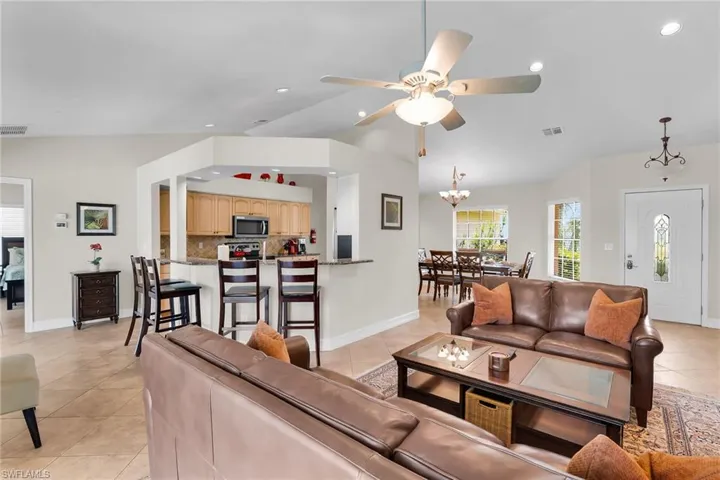 Expansive living area with vaulted ceilings and tile flooring