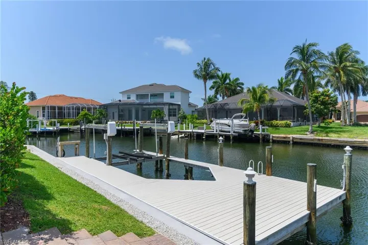 Waterfront property featuring a composite dock and boat lift
